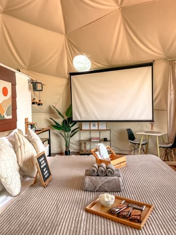 The projector screen set up facing the bed