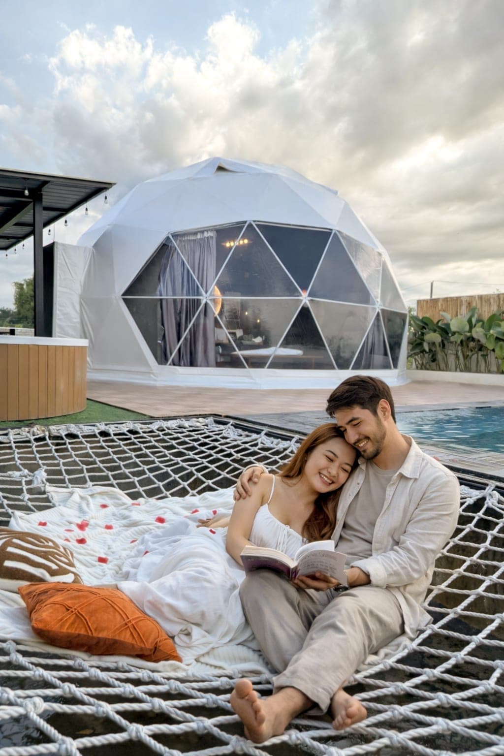 Two guests reading together in the hammock net