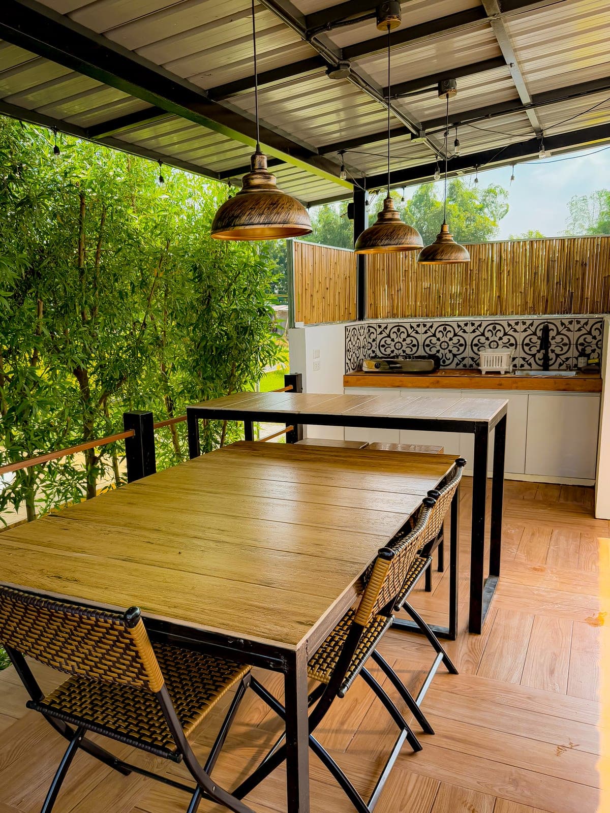 An outdoor kitchen and dining area under a covered deck